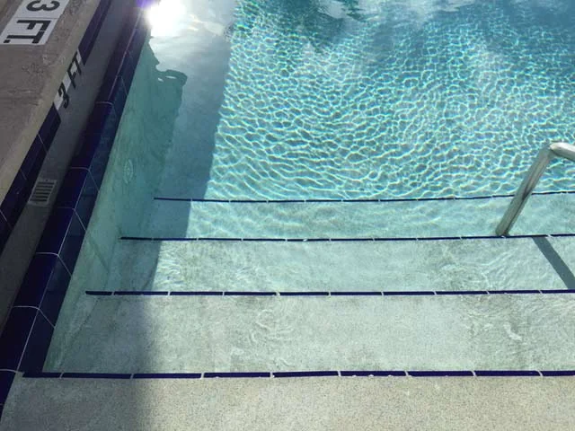 Pool resurfacing steps with blue tile in Jupiter Florida